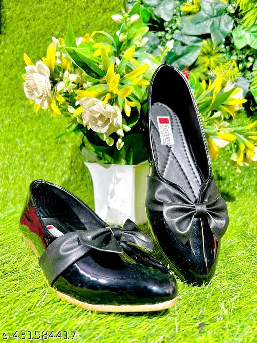 Black, shiny bow heels with a sleek design