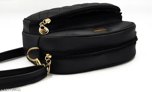 Black sling bag with adjustable strap and metal hardware