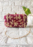 Maroon velvet handbag with chain, featuring two pockets and a top handle