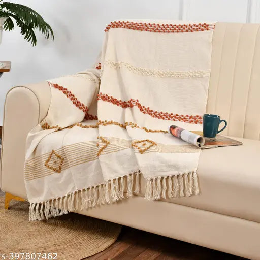 Multicolored fringe throw blanket draped over a couch