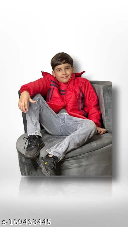 Man wearing red jacket sitting on couch, smiling at camera