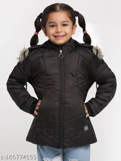 Girl in black faux fur jacket with hood, smiling at camera