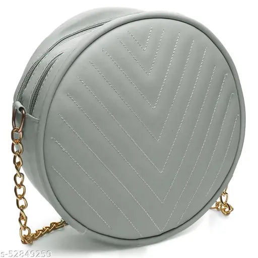 Pale blue PU leather round sling bag with two stitched straps and a golden chain closure