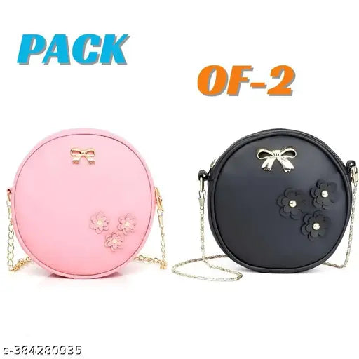 Sleek black purse with pink interior, small round studs, gold lock closure
