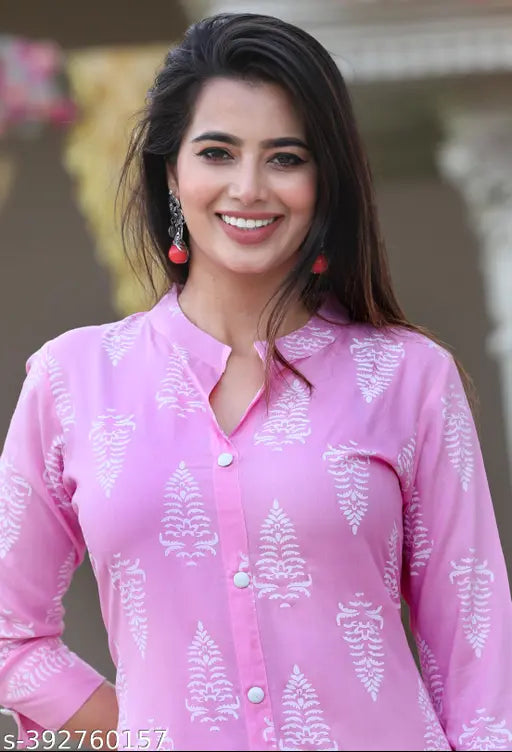The image displays a woman in a pink rayon fabric printed kurti with a palszo set in the background