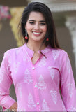 The image displays a woman in a pink rayon fabric printed kurti with a palszo set in the background