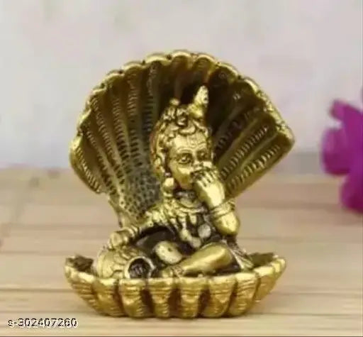 Golden brass idol of Laddu Gopal with naag motif, seated and eating makhan in a petal-shaped holder