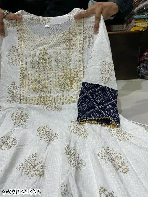White embroidered kameez with gold trim and blue dupatta