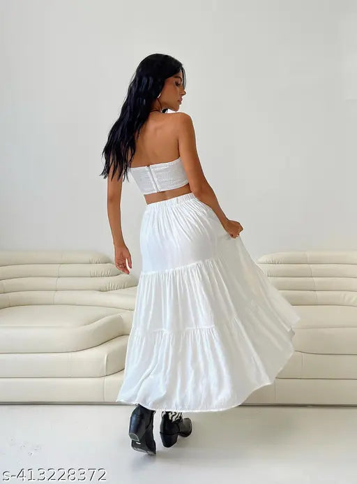 Long, white skirt with ruffles on couch in room