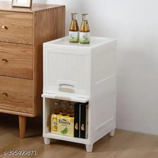 This image features a white, two-sided drawer storage organizer. It has a rectangular shape with multiple compartments designed for various storage needs. The organizer is placed against a light background and appears to be on display for potential buyers. There are books and items inside the drawers, showcasing its versatility for holding different objects