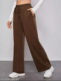 Brown jogger pants with white sneakers in front of a person