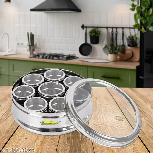 A stainless steel, multipurpose kitchen dabba with eight small airtight containers, suitable for spices or condiments, designed for use in the home