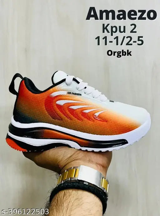 Black and white athletic shoe with orange accents