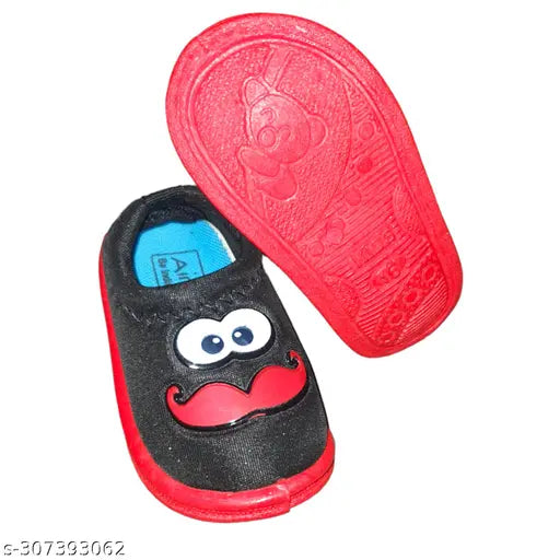 A red, black and white cartoon boy sandal with a blue tag on it