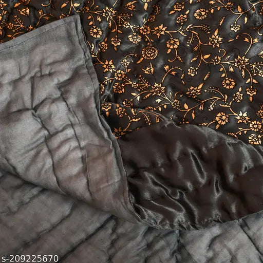 Grey satin double quilt with intricate floral pattern and decorative trim