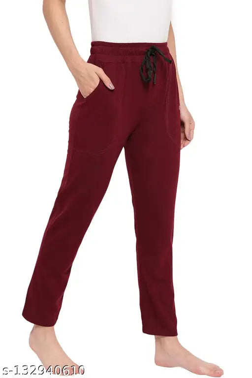 The image shows a woman wearing a pair of maroon cotton pajamas