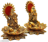 Gold metal idol statues of Lord Laxmi and Ganesh, each on a lotus flower. Art decoration for home. Size 8 x 8 x 10 cm. Vibrant religious showpiece