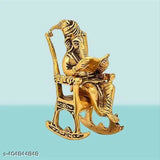 Metal Ganesh reading Ramayana statue, Hindu God Ganesha sitting on swinging chair, decorative showpiece for Diwali or corporate gift. (6 cm x 14 cm x 8 cm)
