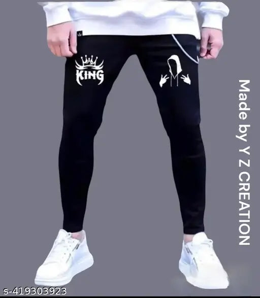 Black denim jeans with white text reading 'KING' and a symbol resembling a crown, featuring a drawstring waistband and two side pockets