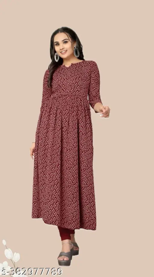 A woman wearing a long-sleeved printed kameez with a flared skirt. The kameez has a mix of dark and light colors, featuring a pattern on a crepe fabric. It is presented in a display setting