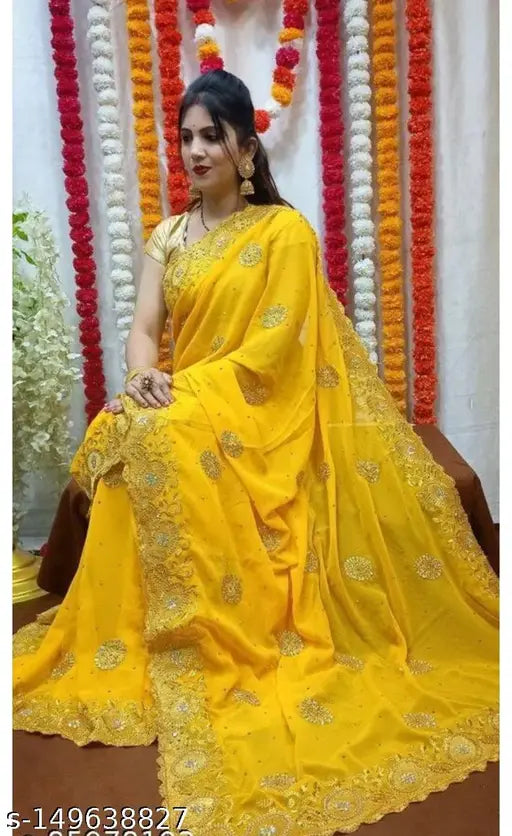 Gold and yellow saree with intricate details and design on a woman seated