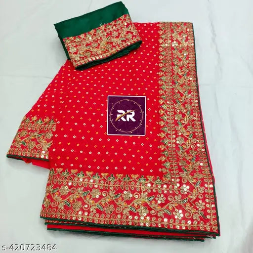 Red bandhani embroidered saree with intricate design, bordered by a red pattern