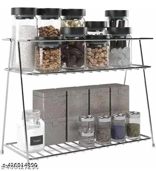 Two-tiered stainless steel kitchen stand with multiple compartments containing spices and utensils