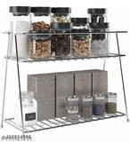 Two-tiered stainless steel kitchen stand with multiple compartments containing spices and utensils