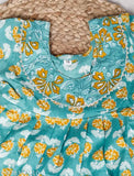 Green floral printed pure cotton kurti dress for baby girls, short sleeves on display