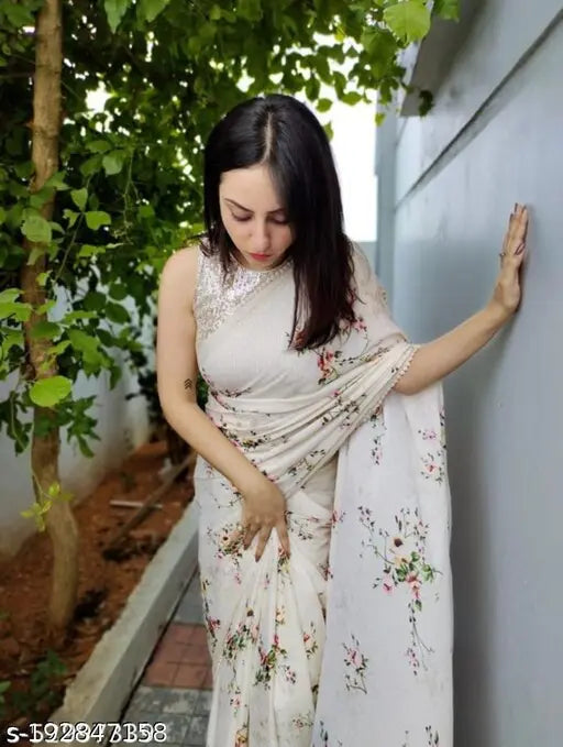 A lightweight, pure georgette saree with matching netted sequence design and enamel print