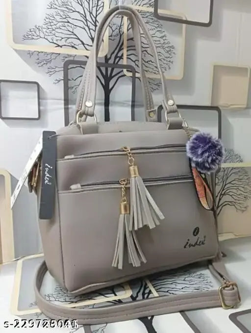 Women's stylish shoulder bag, grey with tassel accents, zip closure, multiple card slots, side handle