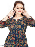 Blue printed long Anarkali gown, rayon, three-quarter sleeves. Woman wearing vibrant all-over print dress in casual setting