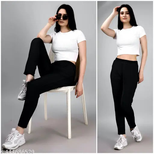Black track pants with high waist and regular comfort fit, as seen on girl in photo