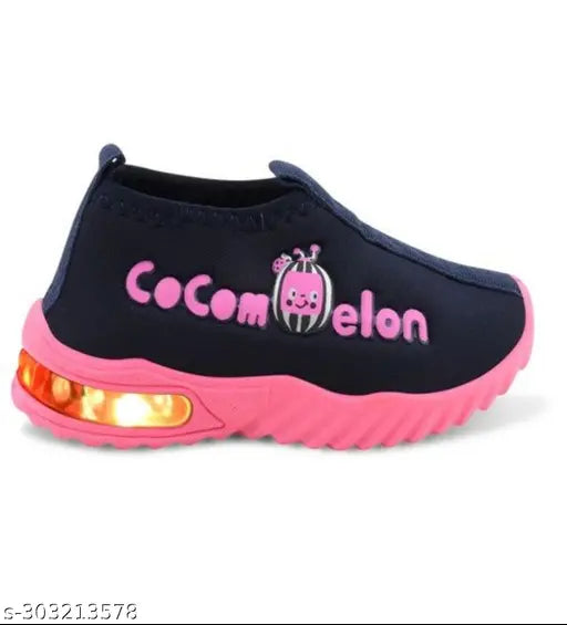 Bright pink and black kids' sneakers, with 'cocomelon' inscription, LED lights along sole, white logo on top, designed for comfort and style