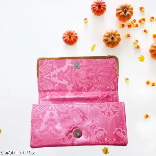 Pink floral patterned wallet with lace detailing and a visible snap closure