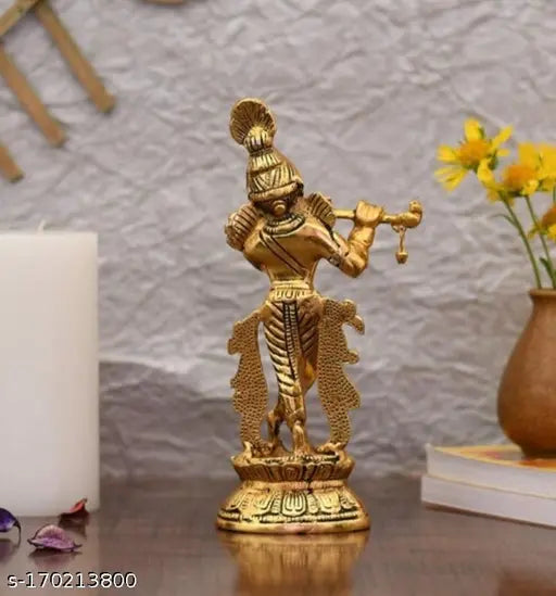Gold metal figurine of Lord Krishna with flute, playing