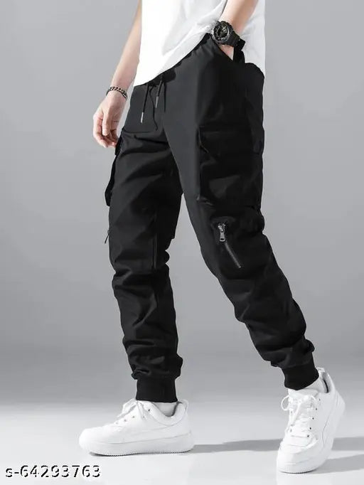 Men's black cotton cargo pants with patch details, elastic waist and drawstring closure. Full-length, casual style with pockets and solid color. Size: M/L/XL/XXL (28" waist x 38" length). Made in India
