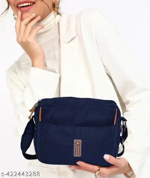 Trendy navy blue polyester sling bag, with a side pocket and shoulder strap