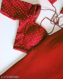 The image is a photograph of a red paisley print saree with a matching blouse draped over it. The blouse features thin, off-the-shoulder straps and appears to be unbuttoned or unzipped in the front, revealing a partial glimpse of an interior top layer beneath. The saree is hanging flat against a white background