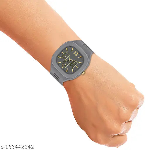The image displays a stylish square dial analog watch with a smooth silicone strap, designed by Adri. The watch features multiple dials and is displayed on a hand. The style of the watch suggests it could be suitable for both boys and men, offering a contemporary and fashionable timepiece option