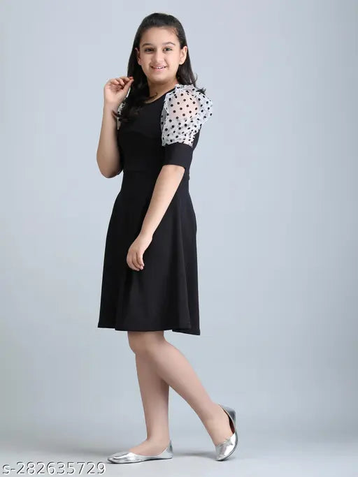 Black cotton blend solid round neck frock dress for girls, ideal for parties or casual events. Made in India