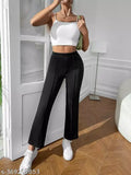 A woman in a white tank top and black high-waisted bell bottom pants