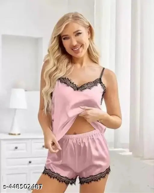 Soft baby pink Malai fabric pajama set for women & girls, featuring lace trim and adjustable spaghetti straps. Made in India