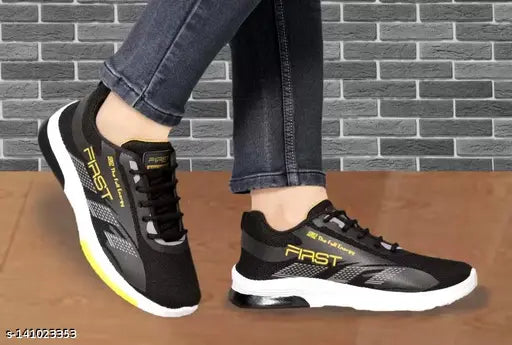 Black casual sports shoes for kids with a white sole and yellow laces
