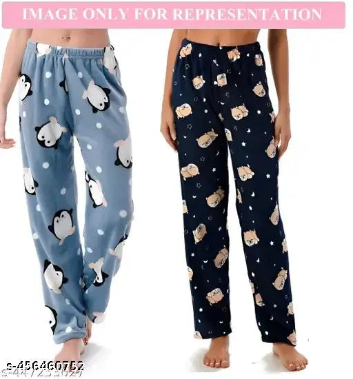 Two pairs of long-sleeved, light blue pajamas featuring a cartoon dog pattern on them. Each pair has an elastic waistband and appears soft and comfortable
