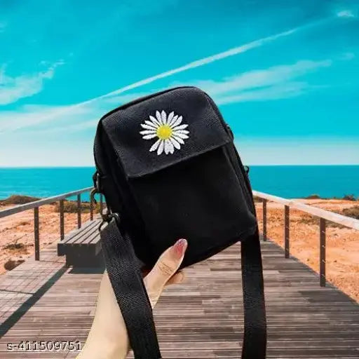 A black flower crossbody bag with multiple compartments, adjustable strap