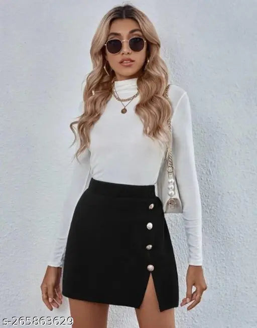 Black pleated skirt with thin strap detail, paired with white turtleneck and sunglasses