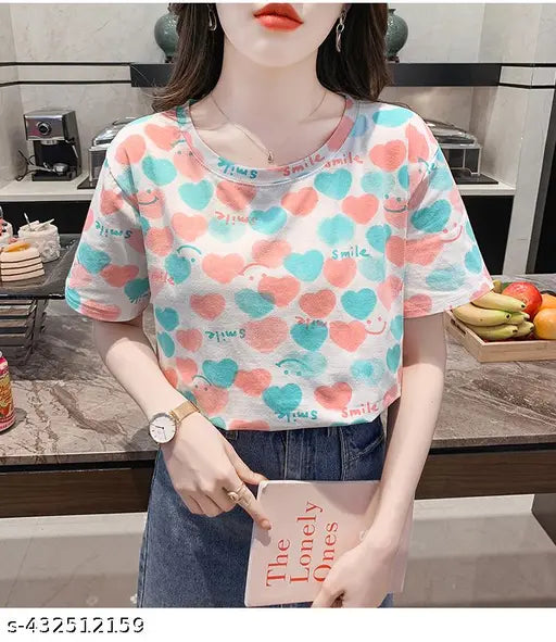 Oversized, long-sleeved, crew-neck printed t-shirt in colorful pastel hues with heart patterns, featuring a playful, stylish design