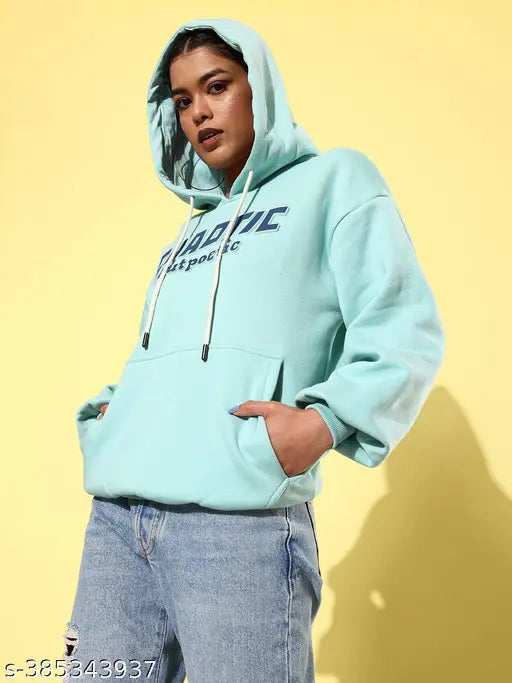 Turquoise blue fleece oversized hoodie with typographic print, perfect for a bold, comfortable style. On model, XS size with bust 39", length 26", waist 39", shoulder 19". Made in India