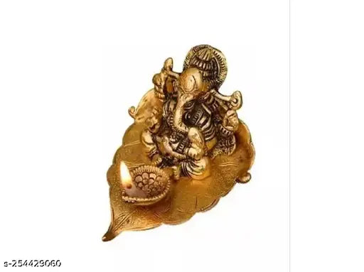 Gold-plated brass Ganesh idol with diya on leaf, ideal for pooja or festive occasions. Brand: MIHSA. India origin